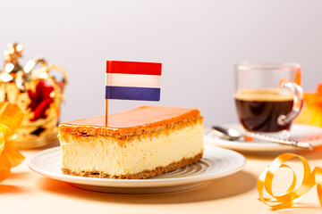 Glazed orange tompouce dessert with Dutch event Kings day in background. National holiday Koningsdag on 27 April in the Netherlands. Holland culture concept