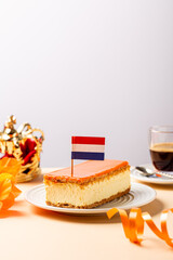 Glazed orange tompouce dessert with Dutch event Kings day in background. National holiday Koningsdag on 27 April in the Netherlands. Holland culture concept with copy space