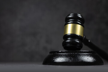 Black judges gavel on the table on a dark background