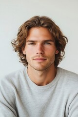 Fototapeta premium Portrait of a Young Man with Long Curly Hair