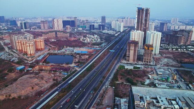 aerial view of financial district with under construction buildings and sky at nanakramguda, Kokapet, hyderabad, telangana, india. day time, semi orbit, drone shot, 4k.