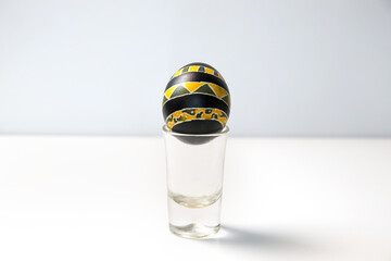 A bright yellow and black Easter egg set against a white background, creating a bold and modern...