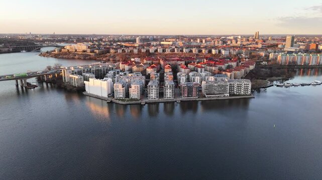 Residential buildings of Lilla Essingen, Stockholm, Sweden, at sunset, aerial view, surrounded by the lake M&auml;laren
