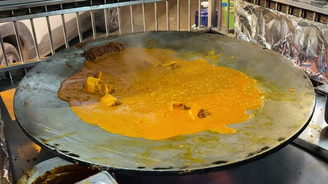 Cooking malai Chaap in a pan on the stove in the kitchen with ingredients like vegetables for a delicious breakfast or lunch meal