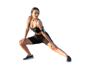 Fotobehang A sporty slim girl in leggings and a top is standing with a training mat, resting between exercises. © Mountains Hunter