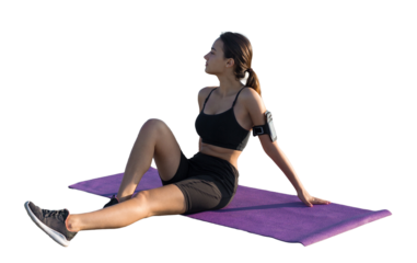 A sporty slim girl in leggings and a top is standing with a training mat, resting between exercises.