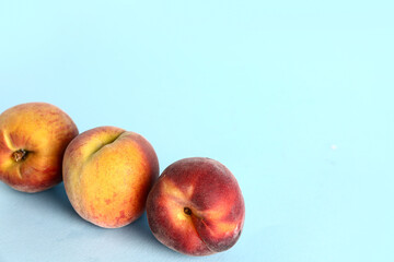 Sweet peaches on blue background