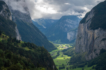Panoramic view of the green Swiss valley taken from the village of Wengen, in the Jungfrau region,...