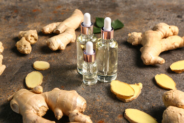 Bottles of ginger cosmetic oil on dark background