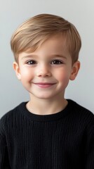 Portrait of a Smiling Toddler Boy with Blonde Hair Wearing a Black Sweater