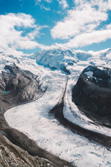 Panoramic view of a Swiss glacier (Gorner Glacier), between snow-capped mountains, in the Zermatt-Matterhorn area.