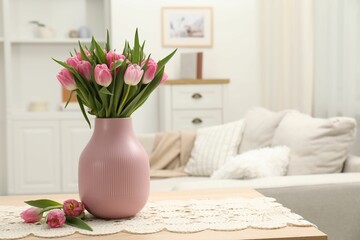 Bouquet of beautiful tulips in vase on table indoors, space for text