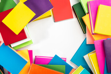 Background of books with copy space. Many colorful books. Concept of school library, children's literature, textbooks for teenagers.