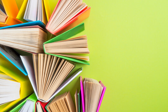 Background of books with copy space. Many colorful books. Concept of school library, children's literature, textbooks for teenagers.