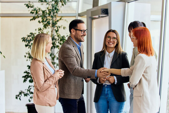 Professional Business Team Shaking Hands During a Friendly Office Meeting