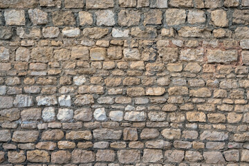 Fototapeta premium Texture of old stone wall background. fragment of beige-gray color decorative stone wall surface. template for design