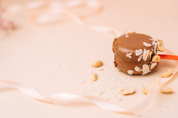 Chocolate french desserts. Cake macaroon on begie background, pastel colors, macaroon decorated with different nuts