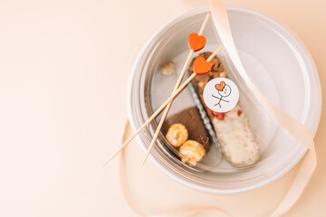 Dessert chocolate bar made at home in a container, milk chocolate with nuts