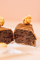 Homemade brownie, chocolate bar in milk chocolate with popcorn on beige background