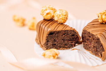 Homemade brownie, chocolate bar in milk chocolate with popcorn on beige background