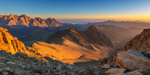 Expansive mountain range at sunrise with warm light rays and distant peaks, ideal for outdoor, nature, and wanderlust imagery