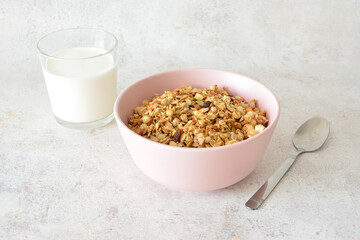 Granola cereal with in a bowl with glass of milk, healthy breakfast