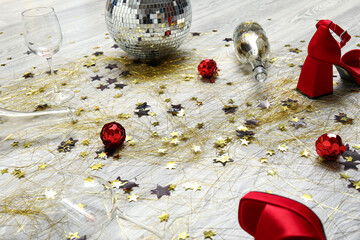 Mess with confetti on light wooden floor after party, closeup