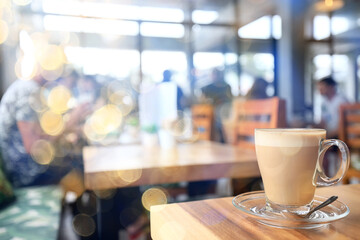 a cup of coffee on a summer morning, sideways sunlight and rays, blurred soft color background, bokeh
