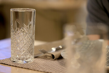table setting in the restaurant, glasses and cutlery, a clean new table in the restaurant is waiting for guests, a free table