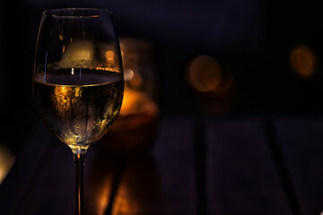 a glass of cold white wine and serving in the restaurant