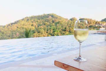 glass of cold white wine on the summer seashore by the water, relaxing by the water, a gentle background of soft color