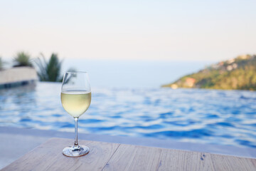 Wine glass close-up in real life, beautiful blurred background of the drink in the glass