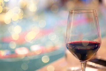 a glass of white wine, a background under the summer sun, a bokeh and sun glare, a blurred abstract...