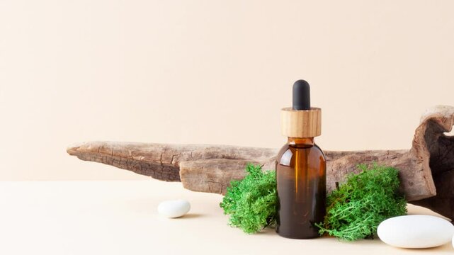 Cosmetic bottle with stones and moss on pastel beige background. Close up, copy space