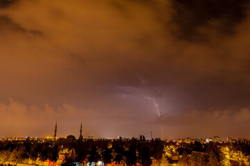 Obraz premium Lightning discharges in the night sky during a thunderstorm. Large thundercloud and lightning discharges. Storm.