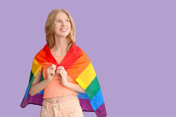 Beautiful young happy woman with LGBT flag on purple background