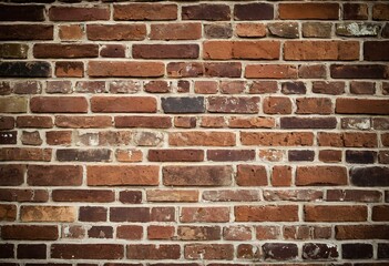 Obraz premium A brick wall with a black floor in front of it.