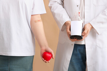 Donor with heart and doctor holding blood pack on beige background