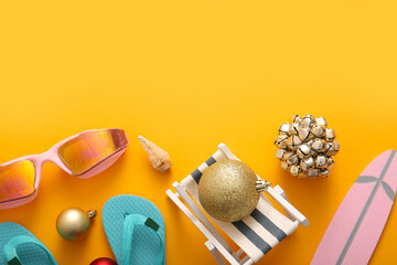 Composition with mini beach accessories, goggles and Christmas decorations on color background
