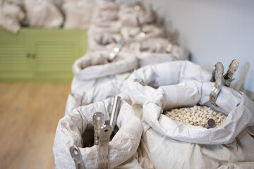 White beans for sale inside reusable bags at grocery store promoting zero waste shopping