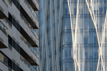 Diagonal reflections on glass building with dynamic vertical elements, high-rise facade ideal for modern urban architecture and premium abstract city design content