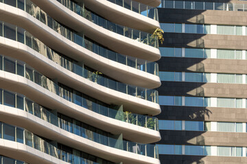 Curved facade detail of modern residential building with soft light, ideal for real estate, architecture and luxury apartment commercial imagery with copy space