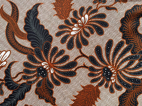 Traditional ethnic fabric in random flower, leaves, swirl, and ornamental pattern. Classic ethnic dyed cloth. Seamless background texture. Indonesian batik illustration.