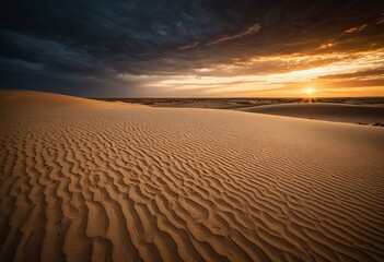 Naklejka premium A sand dune in the middle of a desert at sunset.