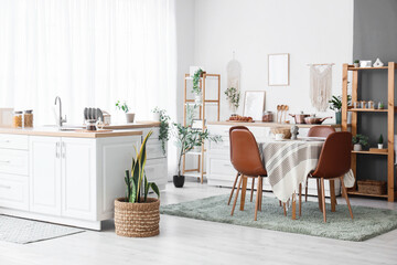 Interior of light dining room with counter, table and chairs