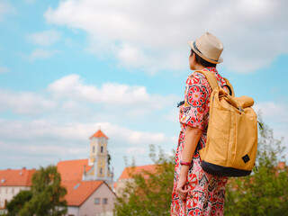 Obraz premium Beautiful woman walking of Varazdin streets during summer day in old, historical city center. Tourist exploring the beautiful streets, view on city from fortess
