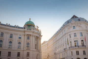 Obraz premium Summer trip to Vienna: exploring city beauty. Hofburg palace on St. Michael square Michaelerplatz, Vienna, Austria. Hofburg - famous Austrian historic landmark in city centre, scenic travel photo.