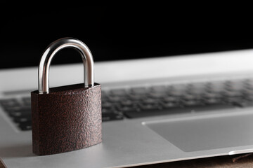 Padlock on laptop, closeup. Cyber security concept