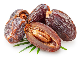 Semi-dried dates and date fruit cut in half lie on palm leaves isolated on white background. File...