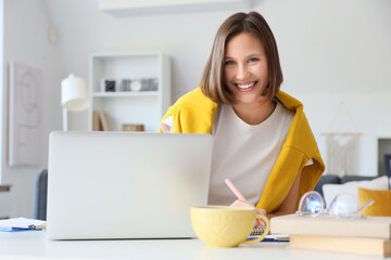 Teenage girl filling out college application form at home